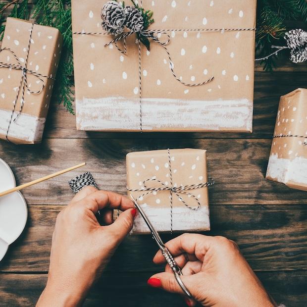 woman wrapping gifts with handmade wrapping paper - sustainable holiday gifts - sustainable holiday gift guide