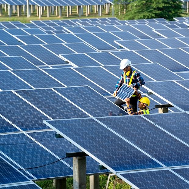 clean energy construction workers building solar farm