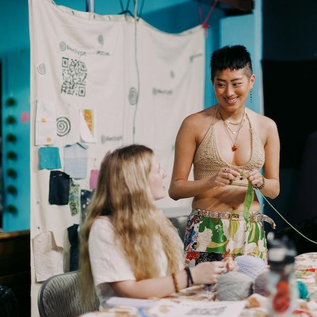 young people repair clothes at a sideline event during climate week 2023 - storytelling for climate justice