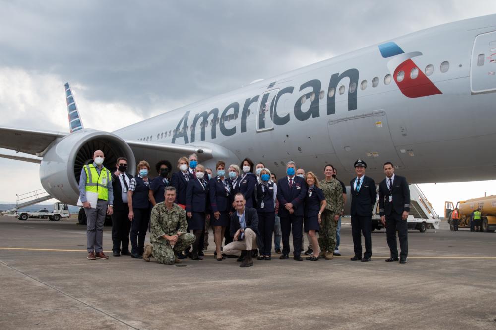 Group standing by American Airlines plane