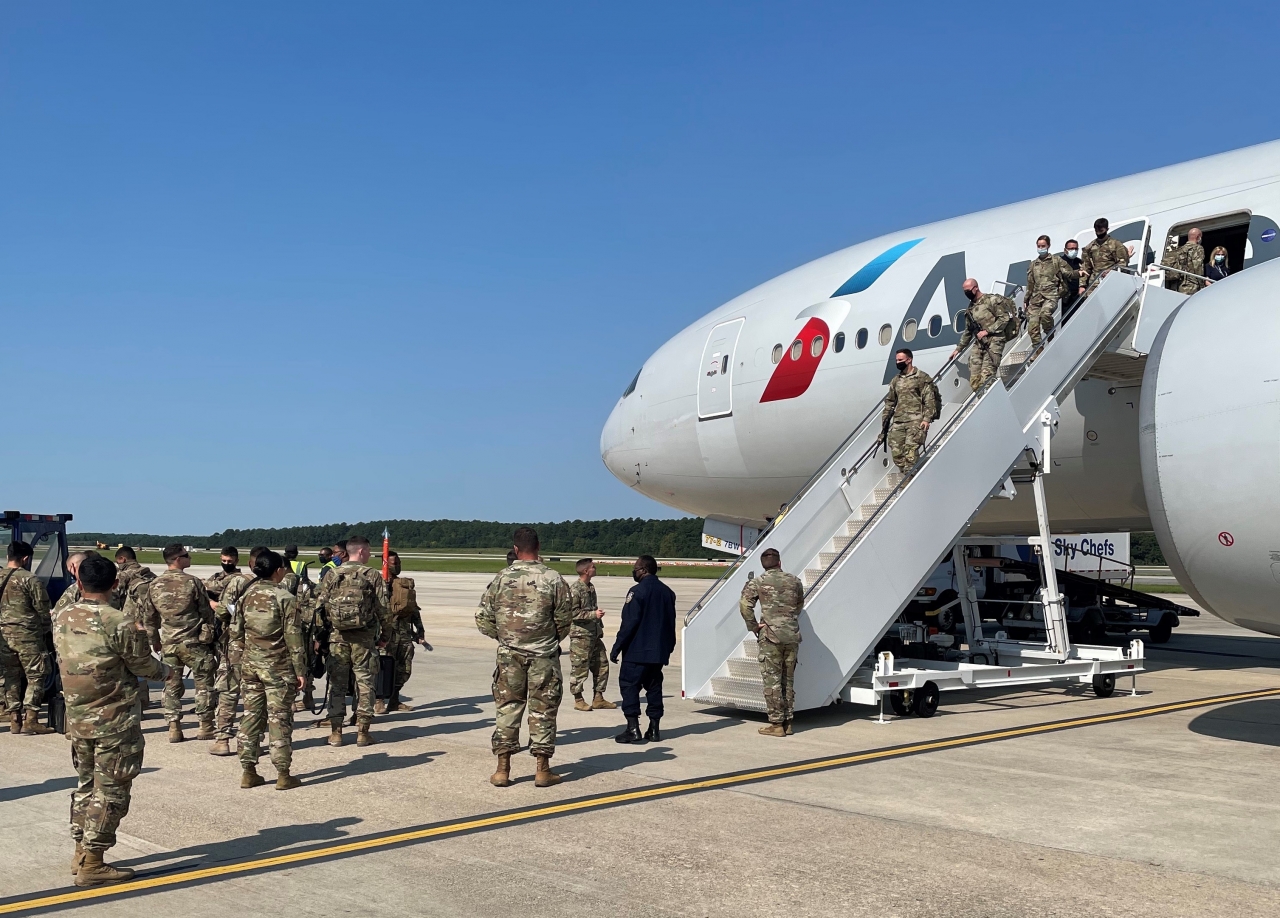 Troops disembarking from plane