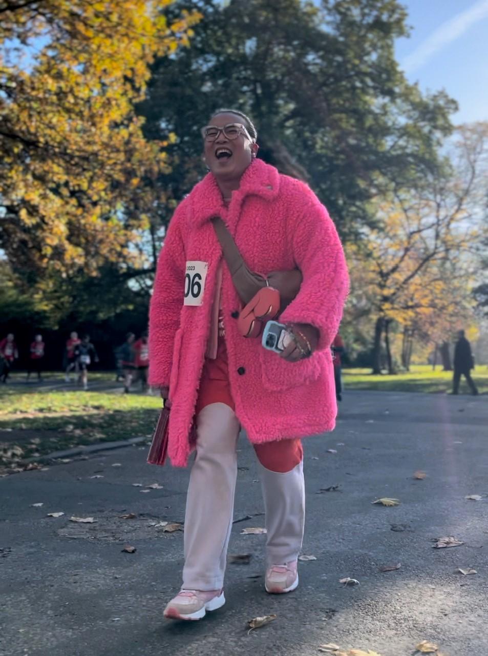 Person walking in bright pink coat