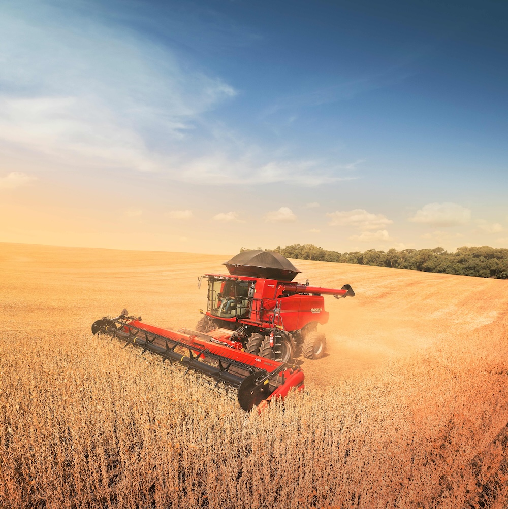 Red farm machine in a field