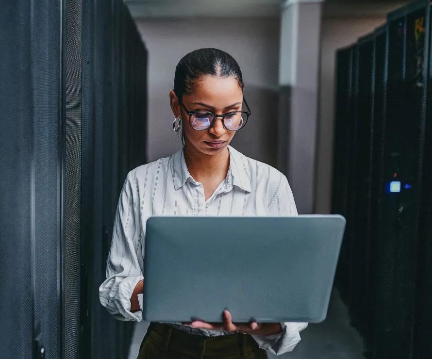 Person standing with open laptop