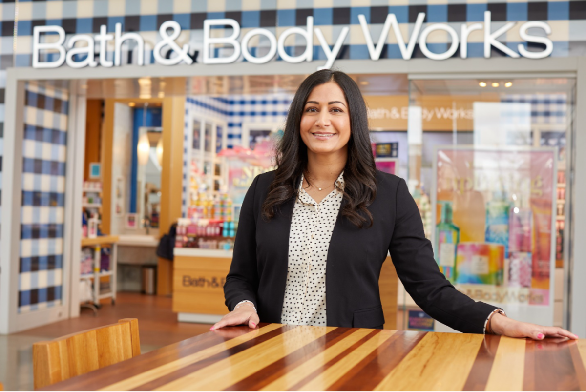 Person standing at a table outside a Bath & Body Works store
