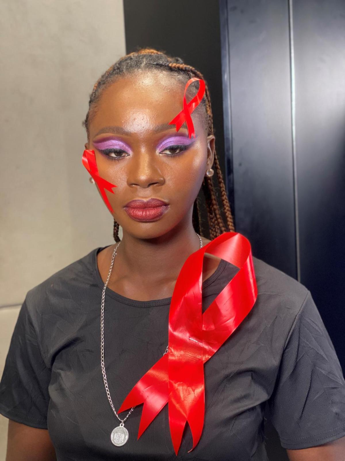 Person with red ribbons on their face and shirt