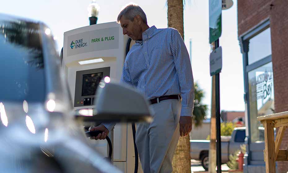 Customer using a duke energy park & plug kiosk