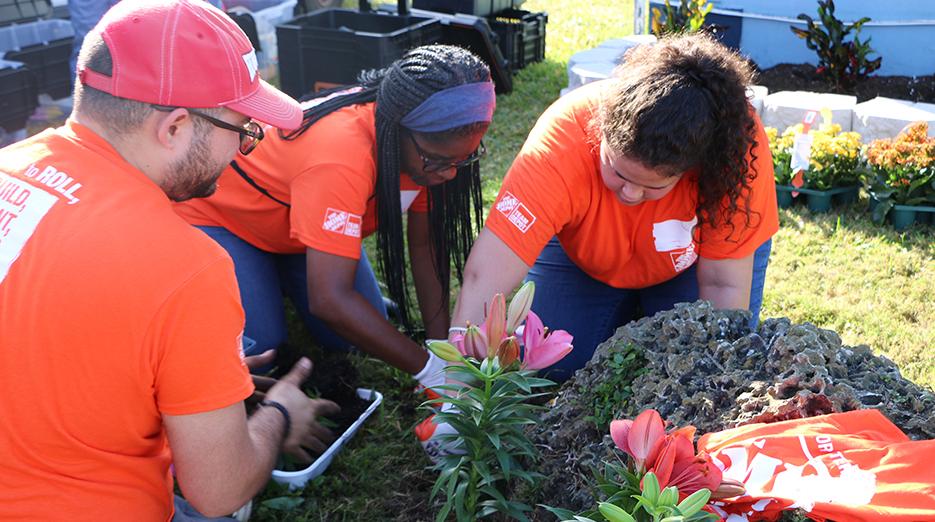 The Home Depot employees planting flowers.