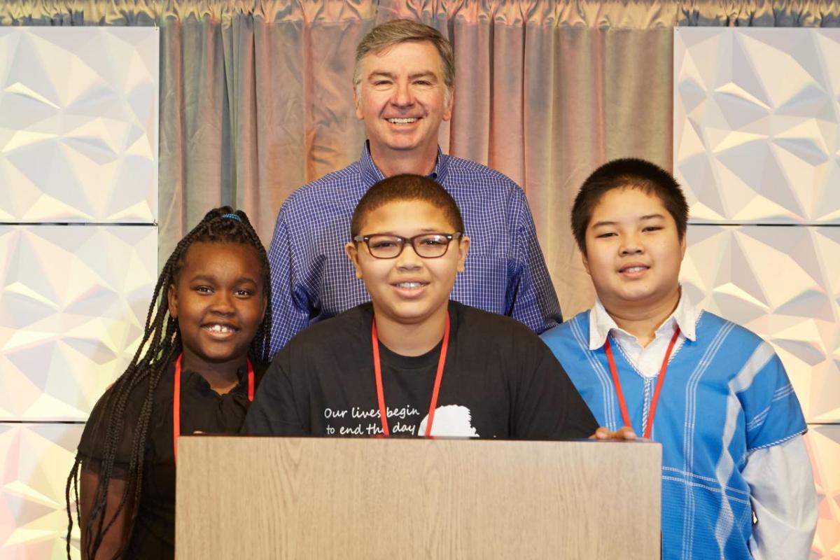 Jim Snee, chairman of the board, president, and chief executive officer of Hormel Foods with winners of the 12th annual Hormel Foods MLK essay contest that included: Ava Pigrum, Sacramento, Calif., Andre Smith, Minneapolis, Minn., and Michael Htoo, Willmar, Minn.