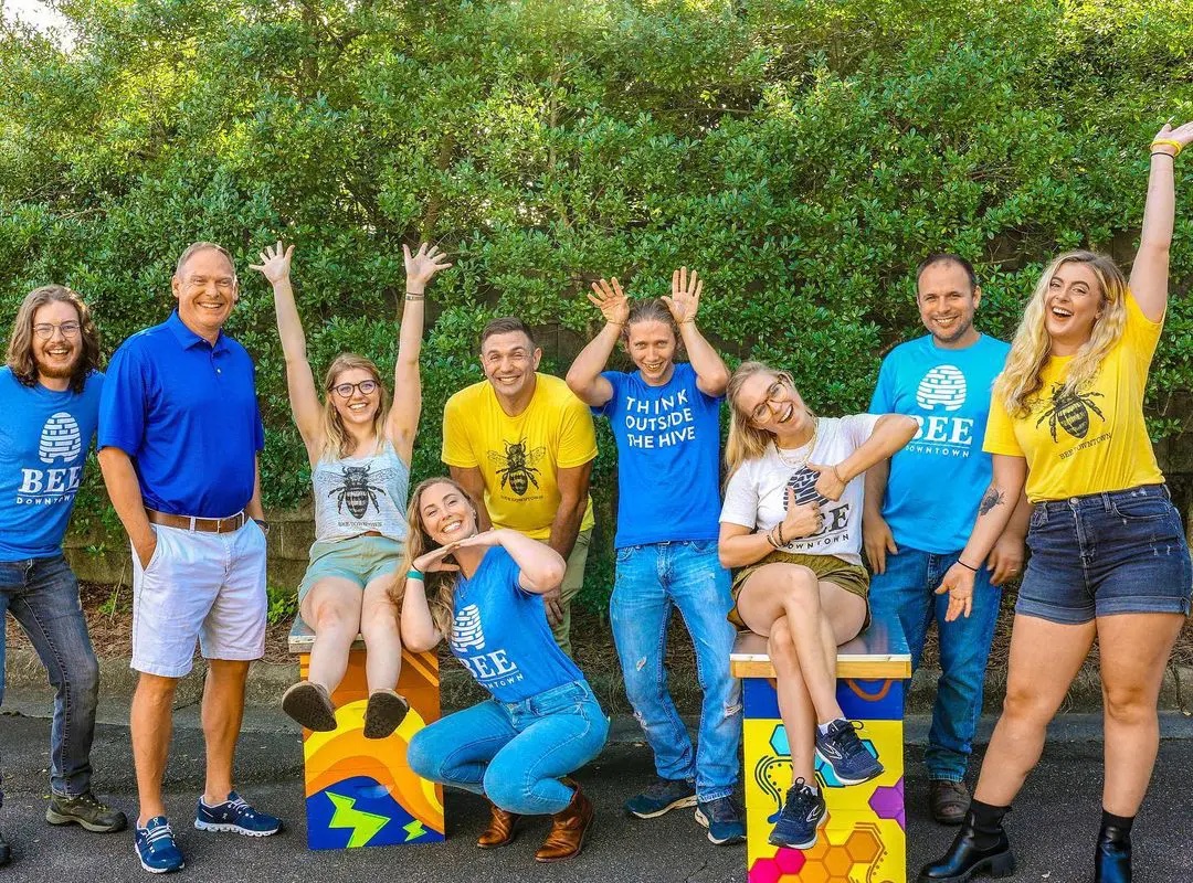 BDT Leadership Institute team members, in yellow and blue, posing and smiling