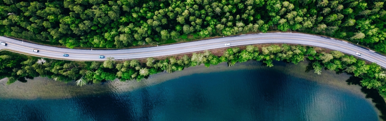 overhead image of cars driving along a windy road 