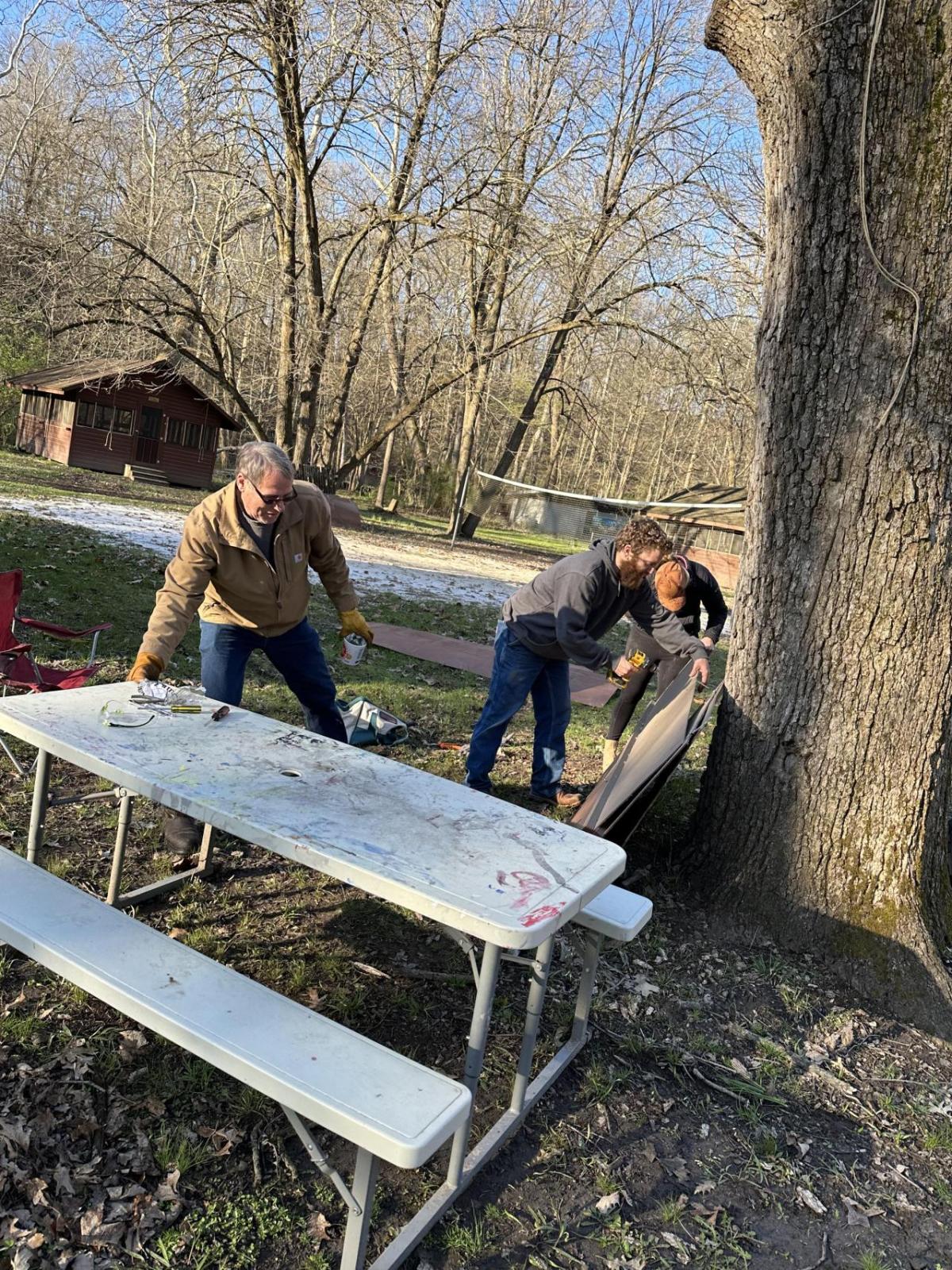 People working near a picnic table