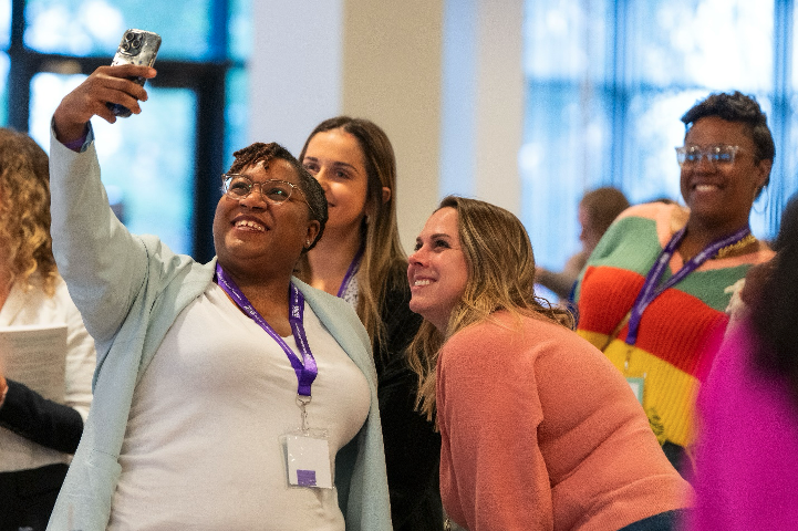 A group of four women smile and crowd together to take a selfie at the Bath & Body Works headquarters in Columbus, Ohio.