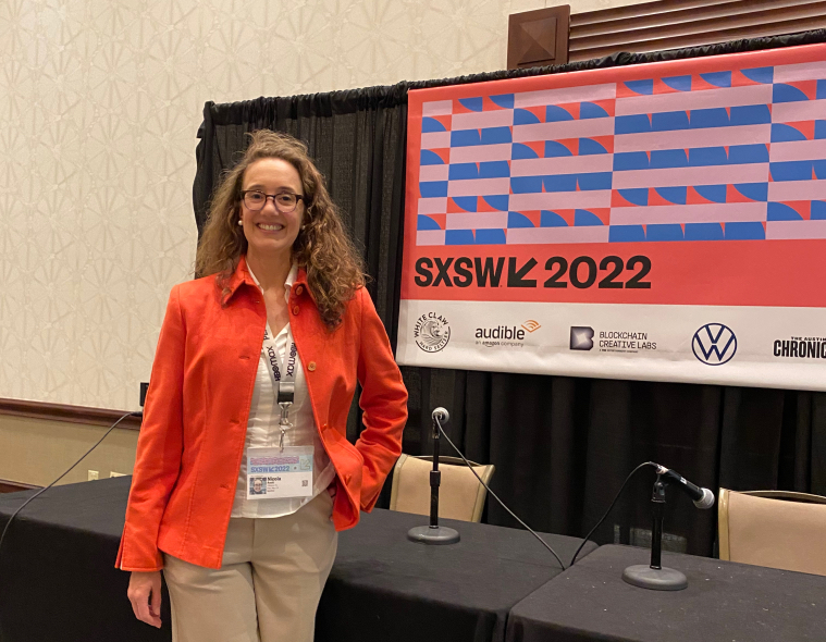 Nicola Acutt, vice president of ESG at VMware, stands at SXSW 2022 booth