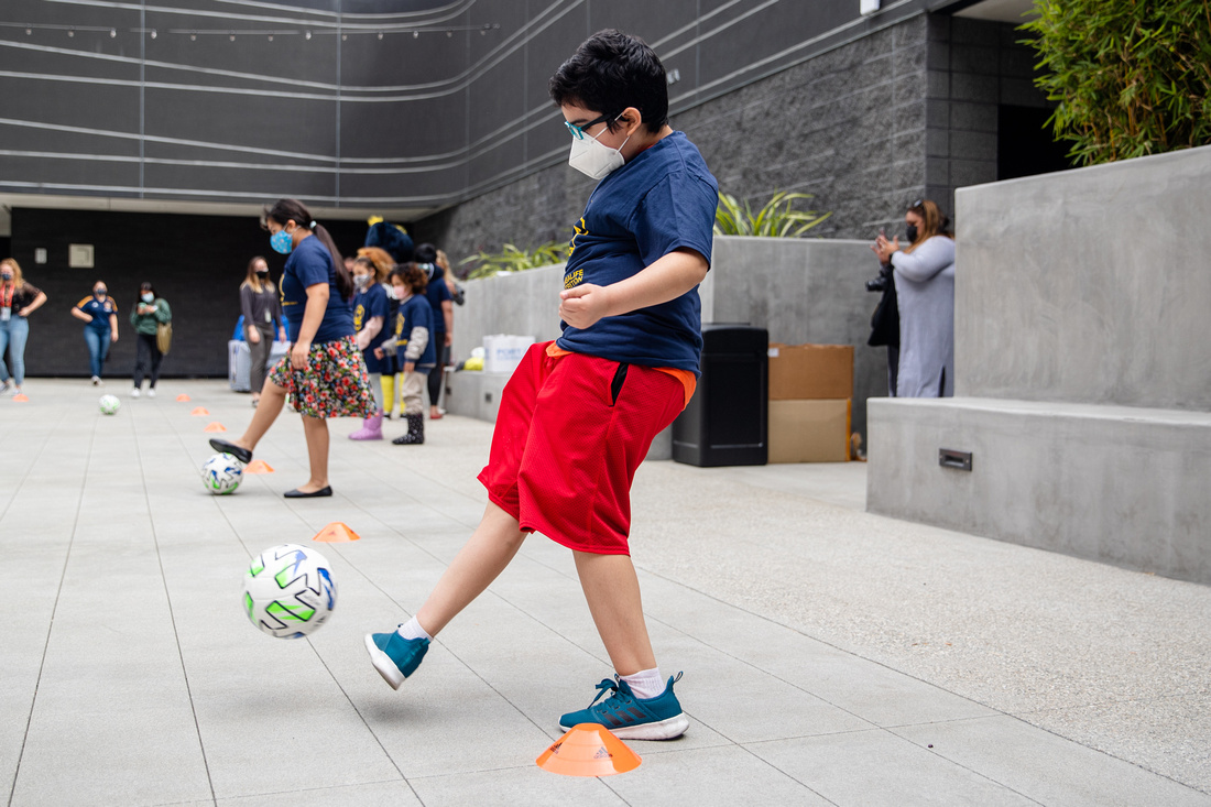 Youth participants from Little Tokyo Service Center test out the newly donated soccer equipment from the LA Galaxy with club staff at the new Terasaki Budokan complex in downtown Los Angeles on May 10 2021