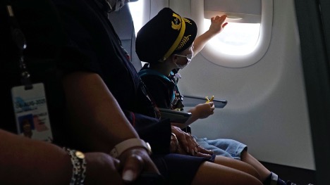 Child looking out of an airplane window