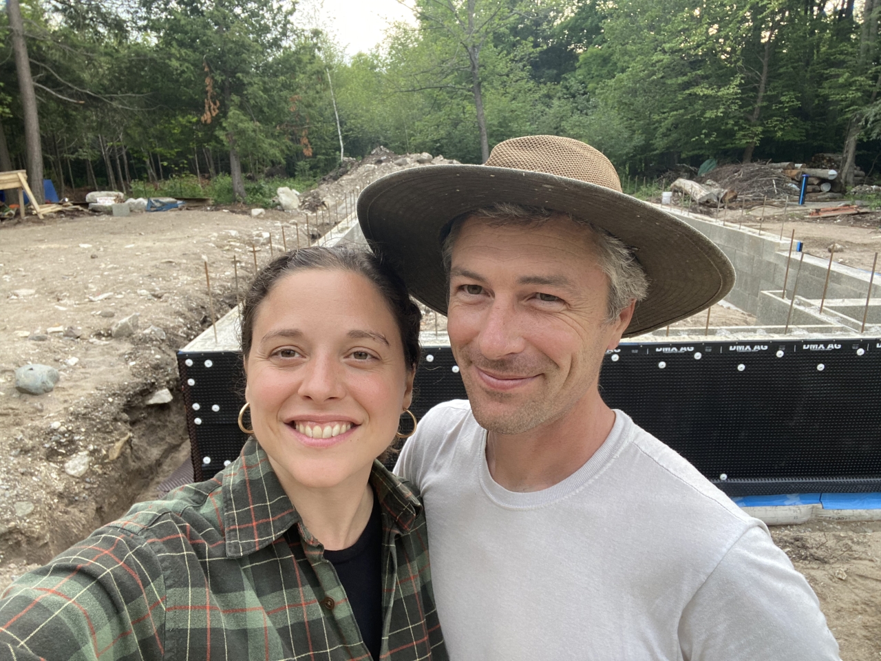 Andrea Ruotolo and husband Tristan in front of the net zero home they are building