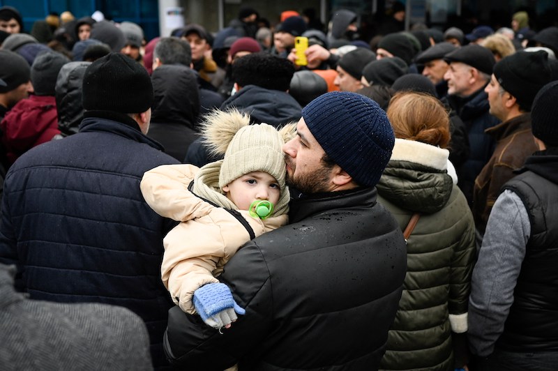 Man holding his daughter in Ukraine.