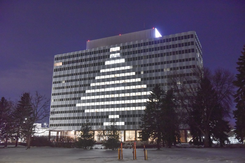 3M building with lit windows to form a tree