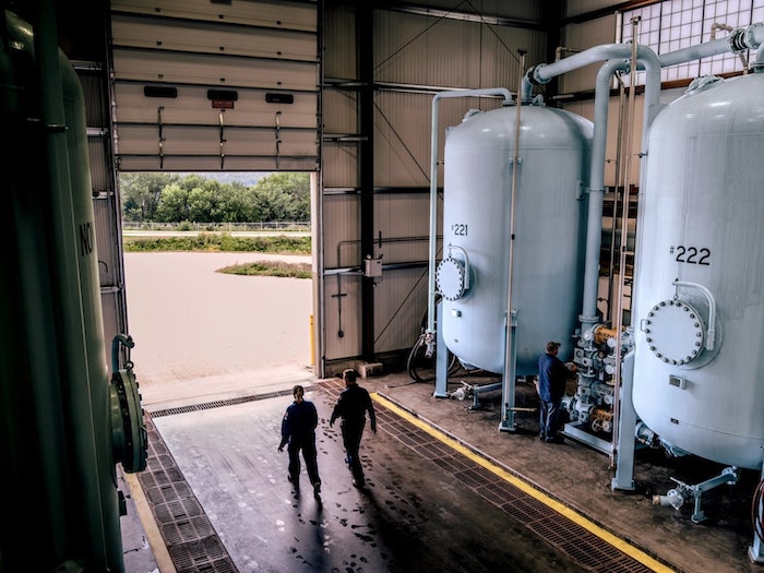 3M manufacturing facility in Cordova, Illinois. Two men are pictured walking out of the building.