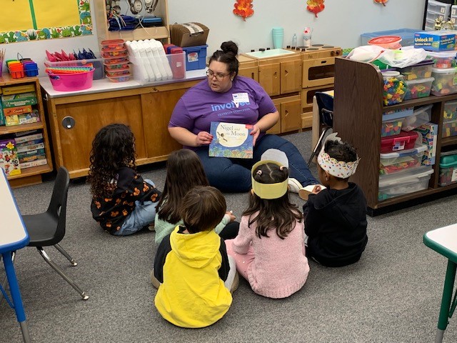 employee reading to kids