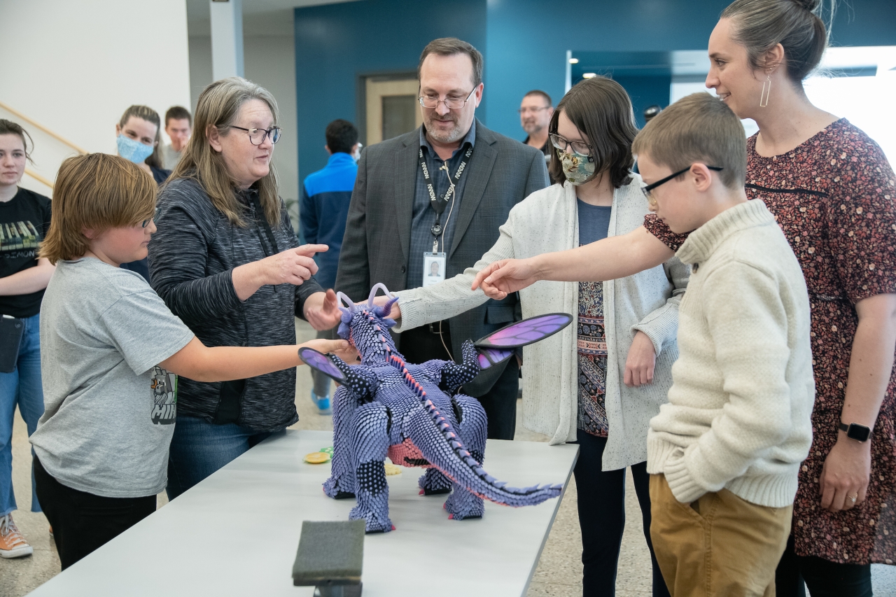 Frank Piotrowski and students at St. Vrain Innovation Center with Belle's Dragon 