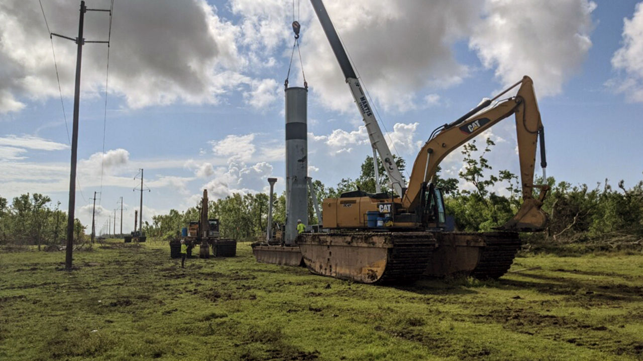 3 pieces of heavy machinery in a field