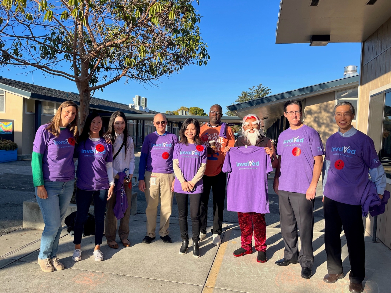 group of employees in purple T-shirts