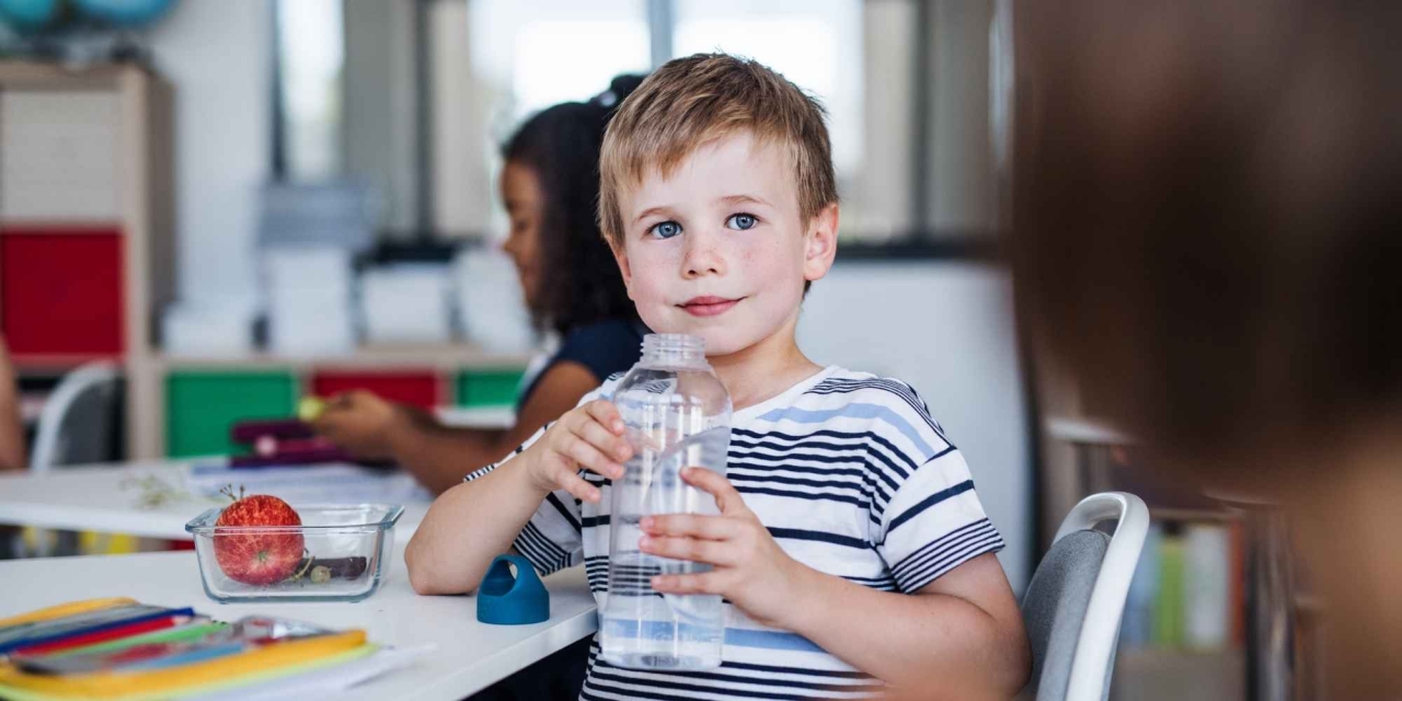 Delos:  Boy with water bottle. 
