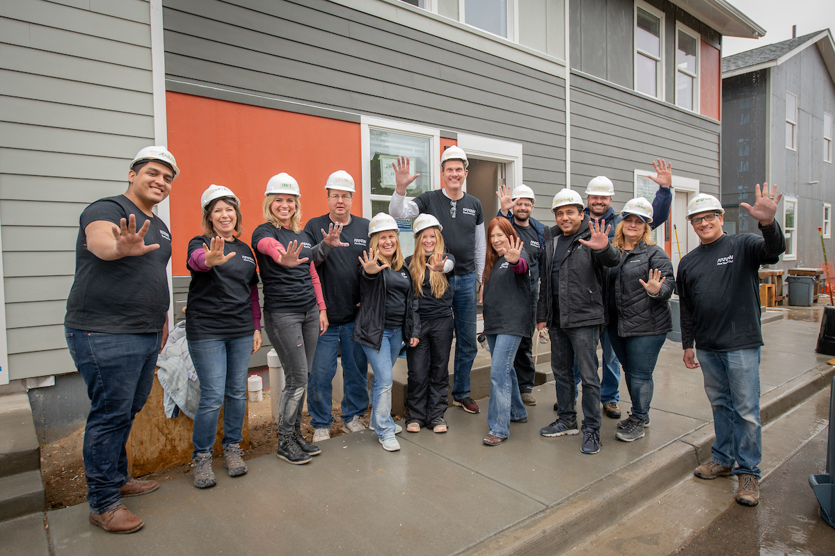 Arrow employees pose for a group photo while on the Habitat for Humanity build site