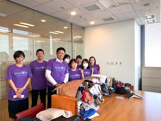 group of volunteers with bags of clothing