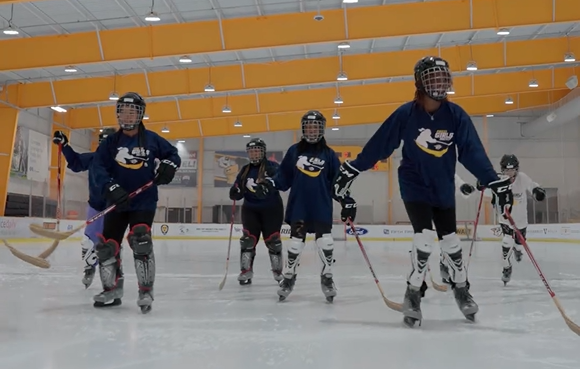 Members of Play Like a Girl participate in a hockey clinic
