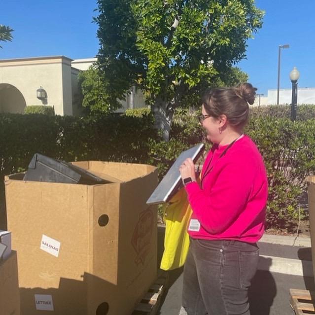 Woman placing laptop in cardboard box