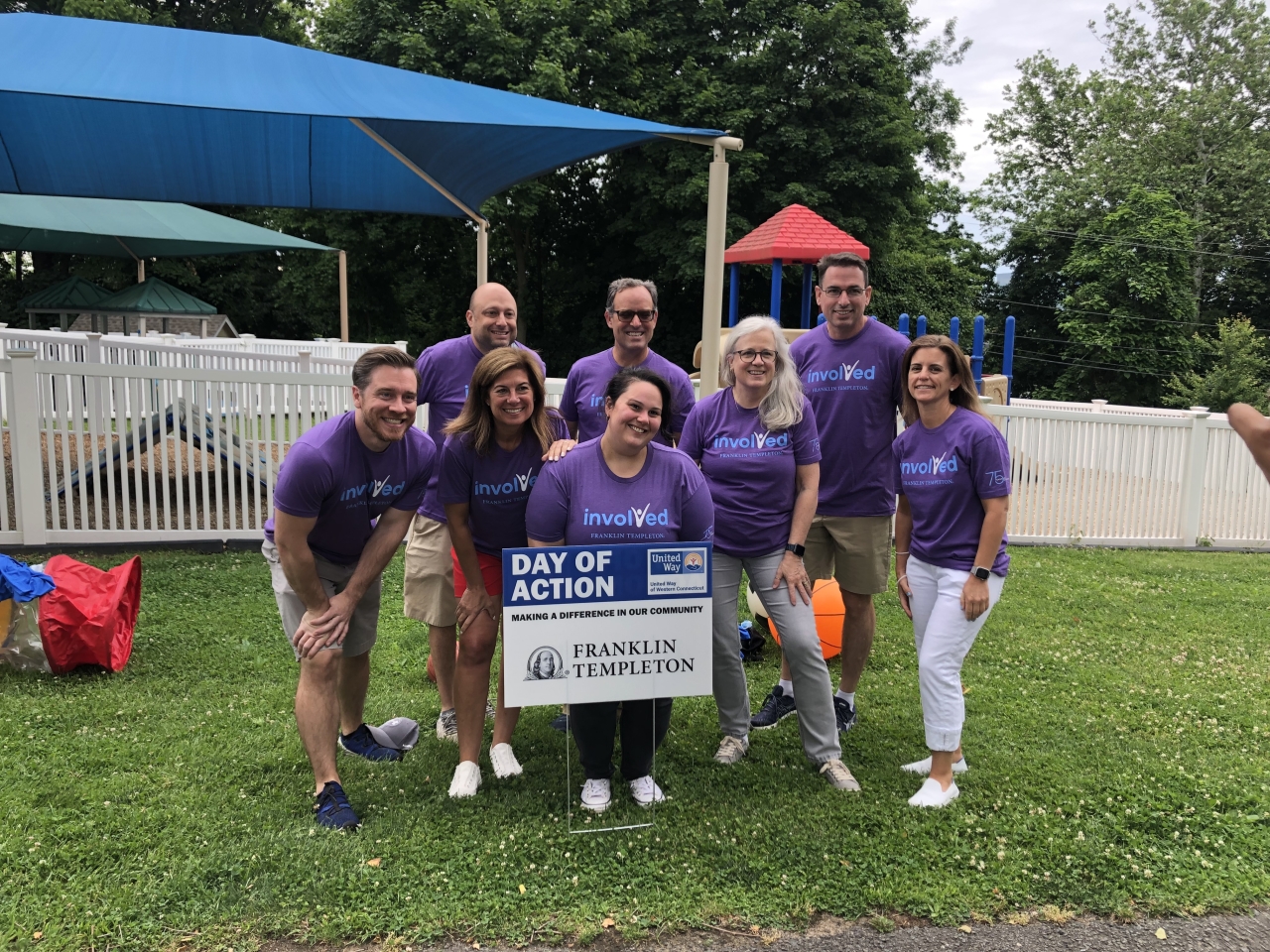 group of volunteers with sign "Day of Action"