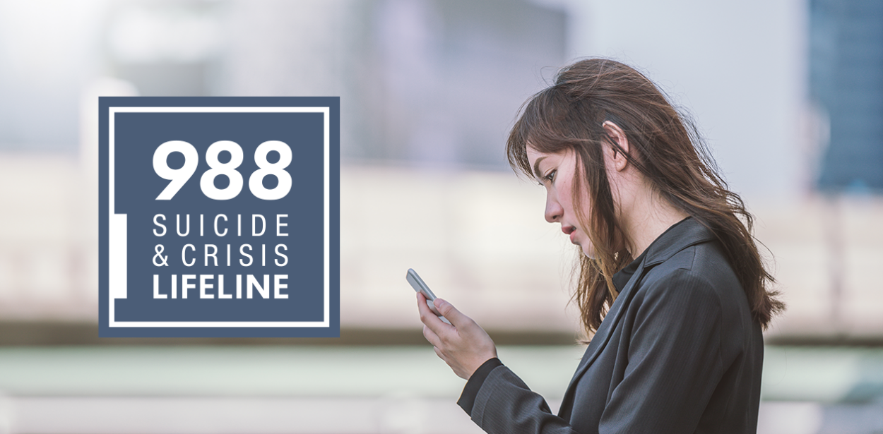 a person looking at a phone. The 988 suicide & crisis lifeline logo on the left