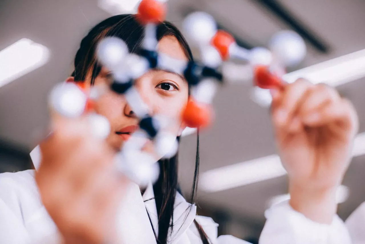 Scientist holding model of a molecule 