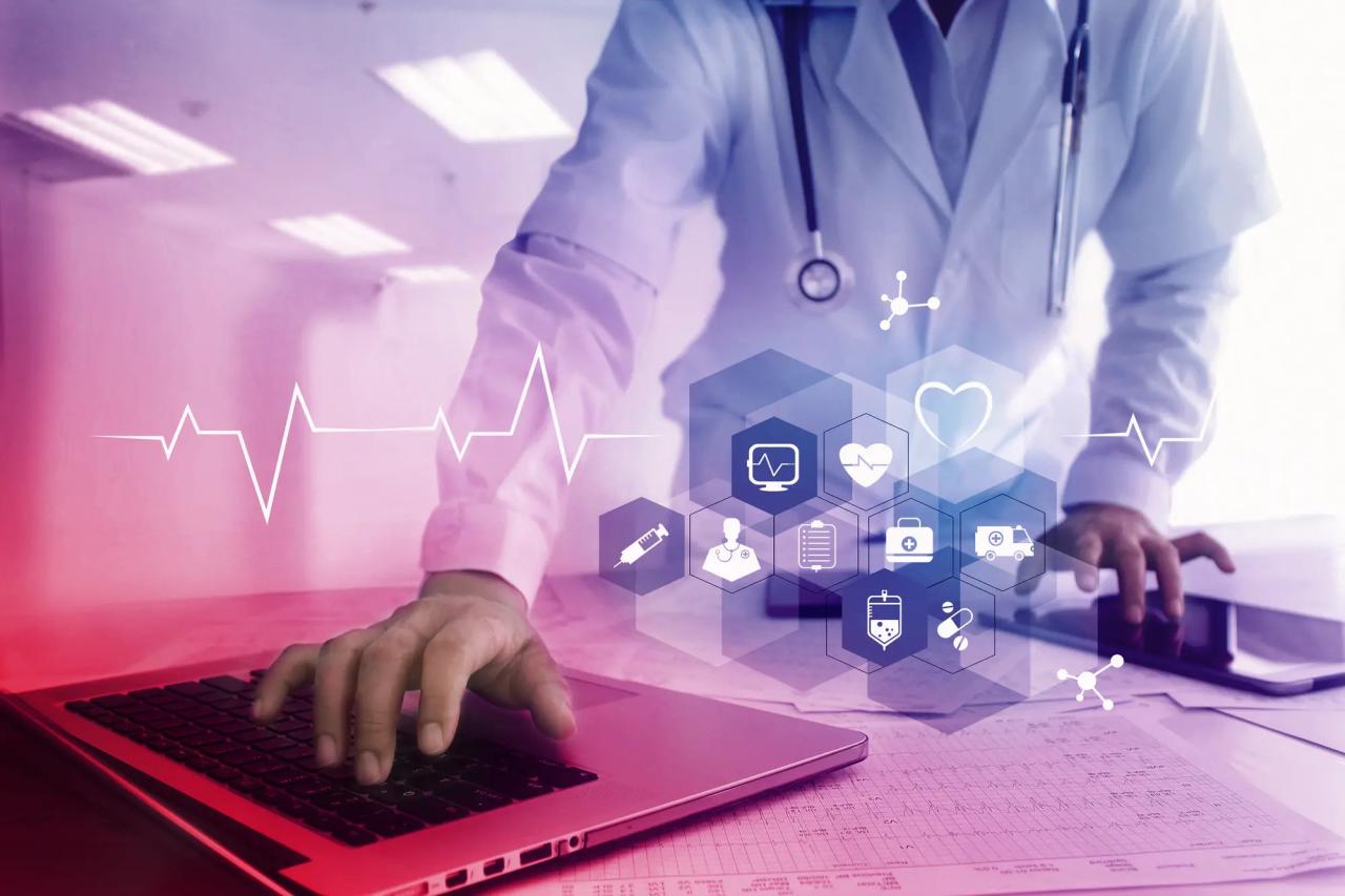 A healthcare professional using a laptop. Superimposed medical symbols.