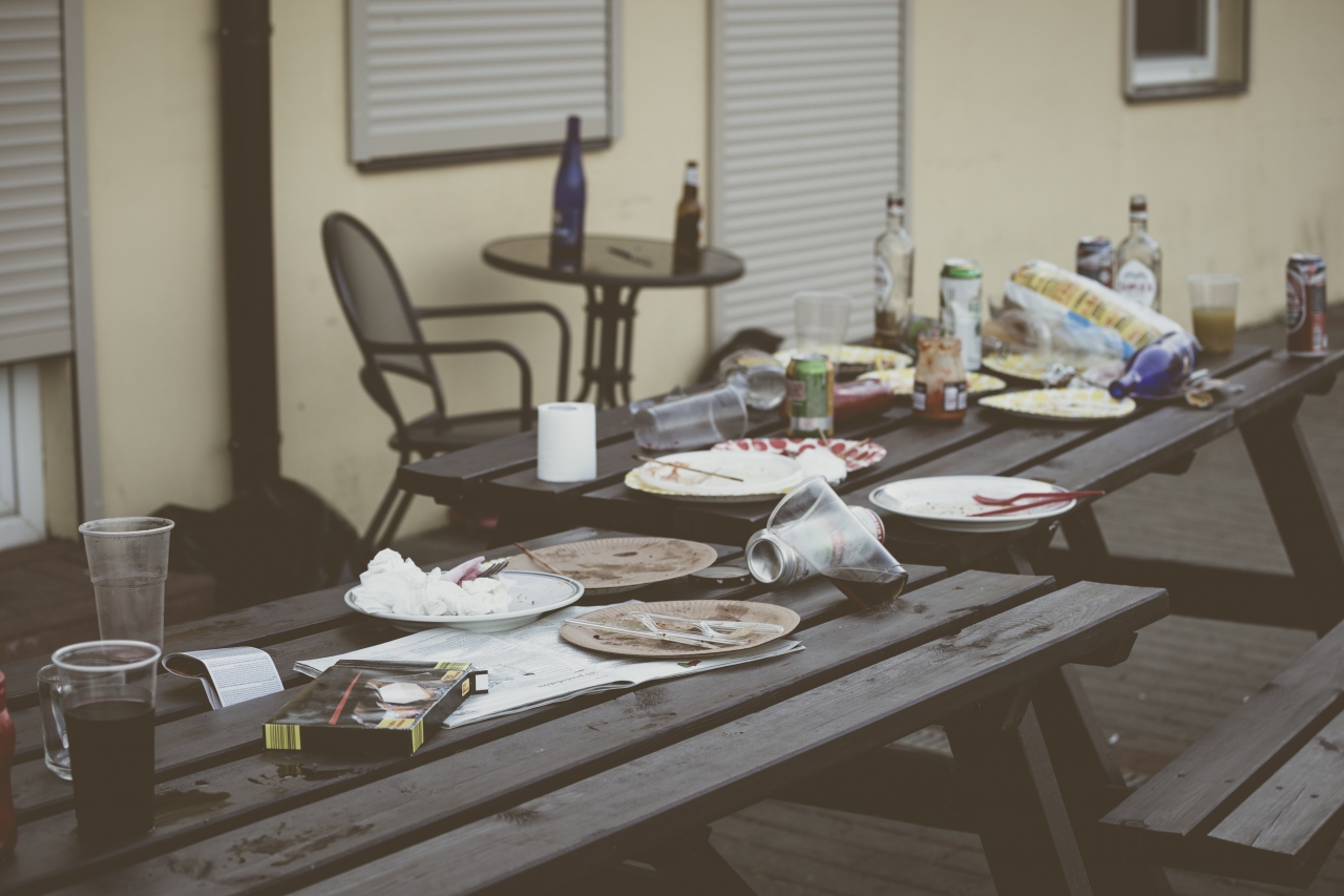 trash on a picnic table after a party