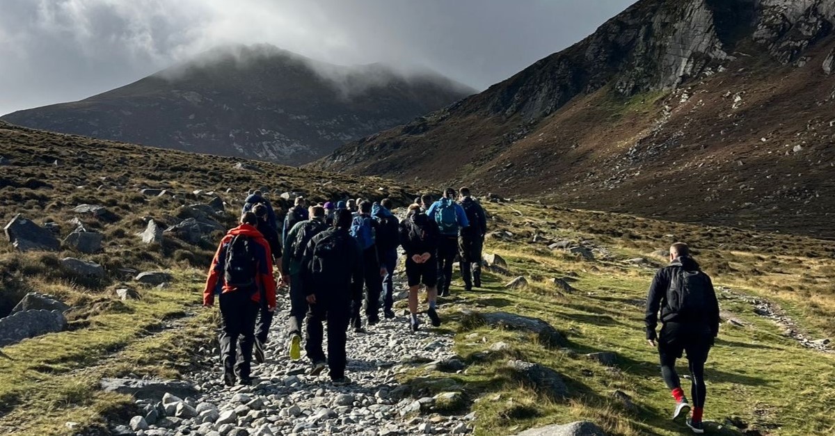 Aflac Northern Ireland volunteers on the Three Peaks Challenge, a trek to the Mournes that includes Slieve Binnian, Slieve Commedagh and, finally, an ascent to the top of Slieve Donard.