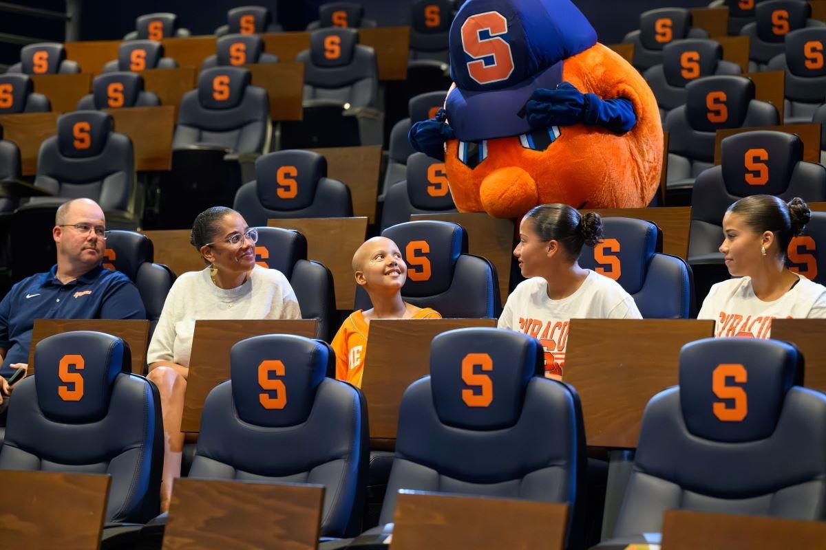 Judy with her family and Syracuse Head Football Coach Fran Brown.