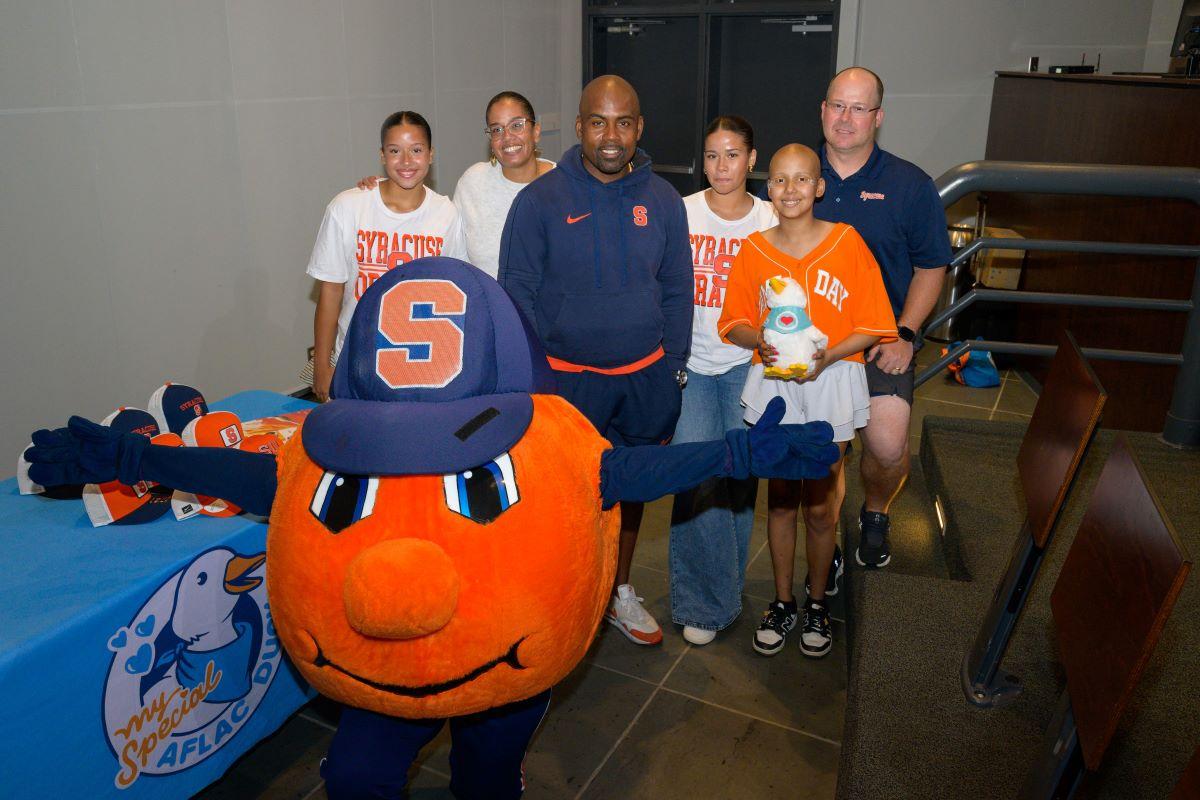 Judy in the stands with the Syracuse mascot.