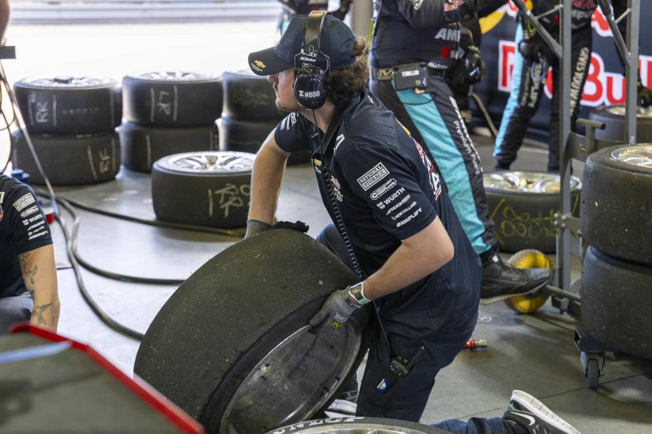 person lifting a tire