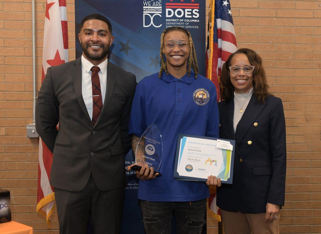 Ashanti Hunt holding an award and certificate 