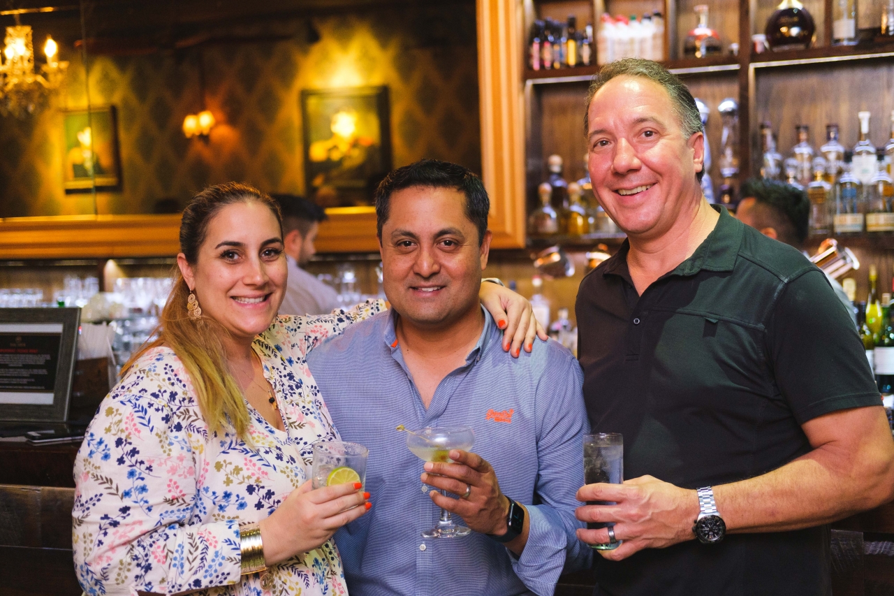 Three Bacardi team members holding drinks 