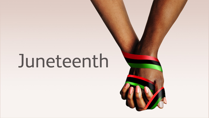 Juneteenth: Hands wrapped in Red, black and green ribbons.