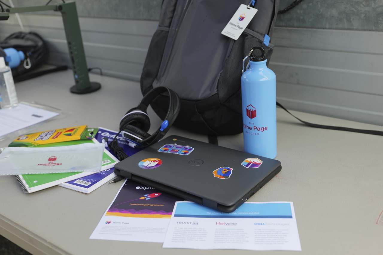 Backpack with water bottle, colored pencils, computer, and headset