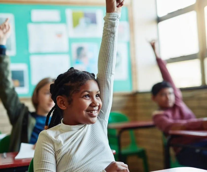 child raising her hand