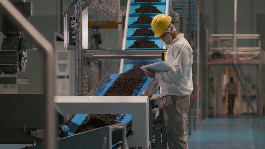 factory worker checking a machine