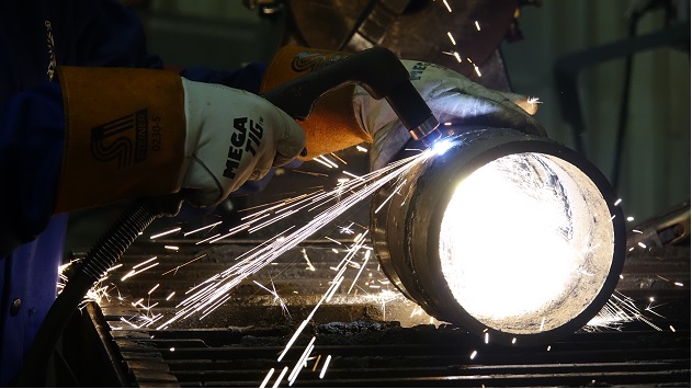 close up of a welding torch being used on a metal tube