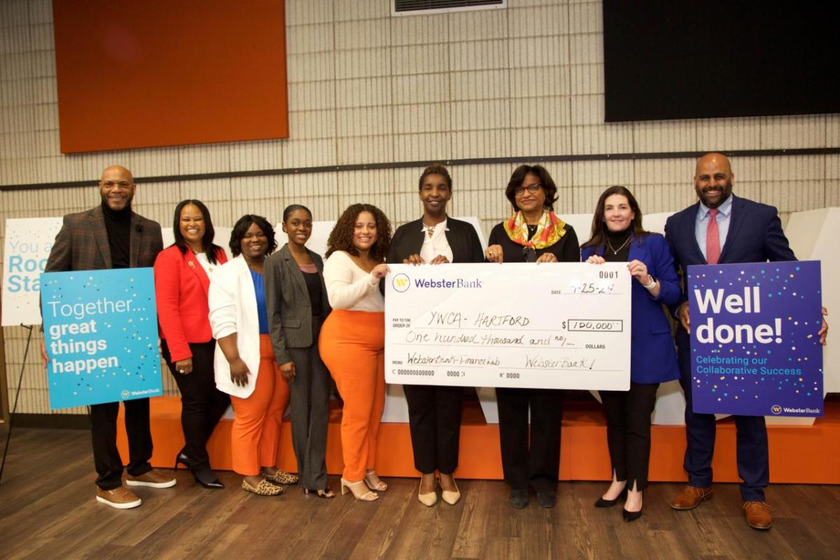 group standing with an oversized check